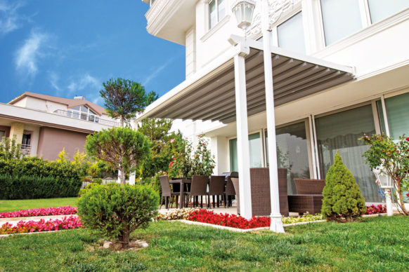 Attached pergola with retractable canopy and sloped roof