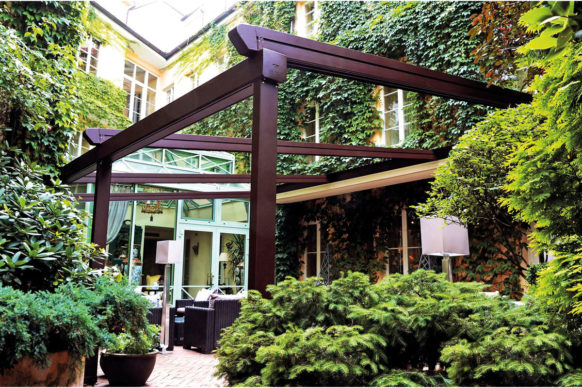 Attached pergola with retractable canopy and sloped roof