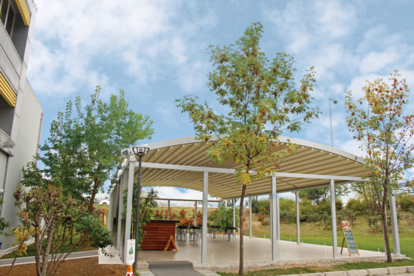 Freestanding Pergola with retractable canopy and curved roof